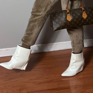 White, hidden wedge bootie with gold zipper detail on the back